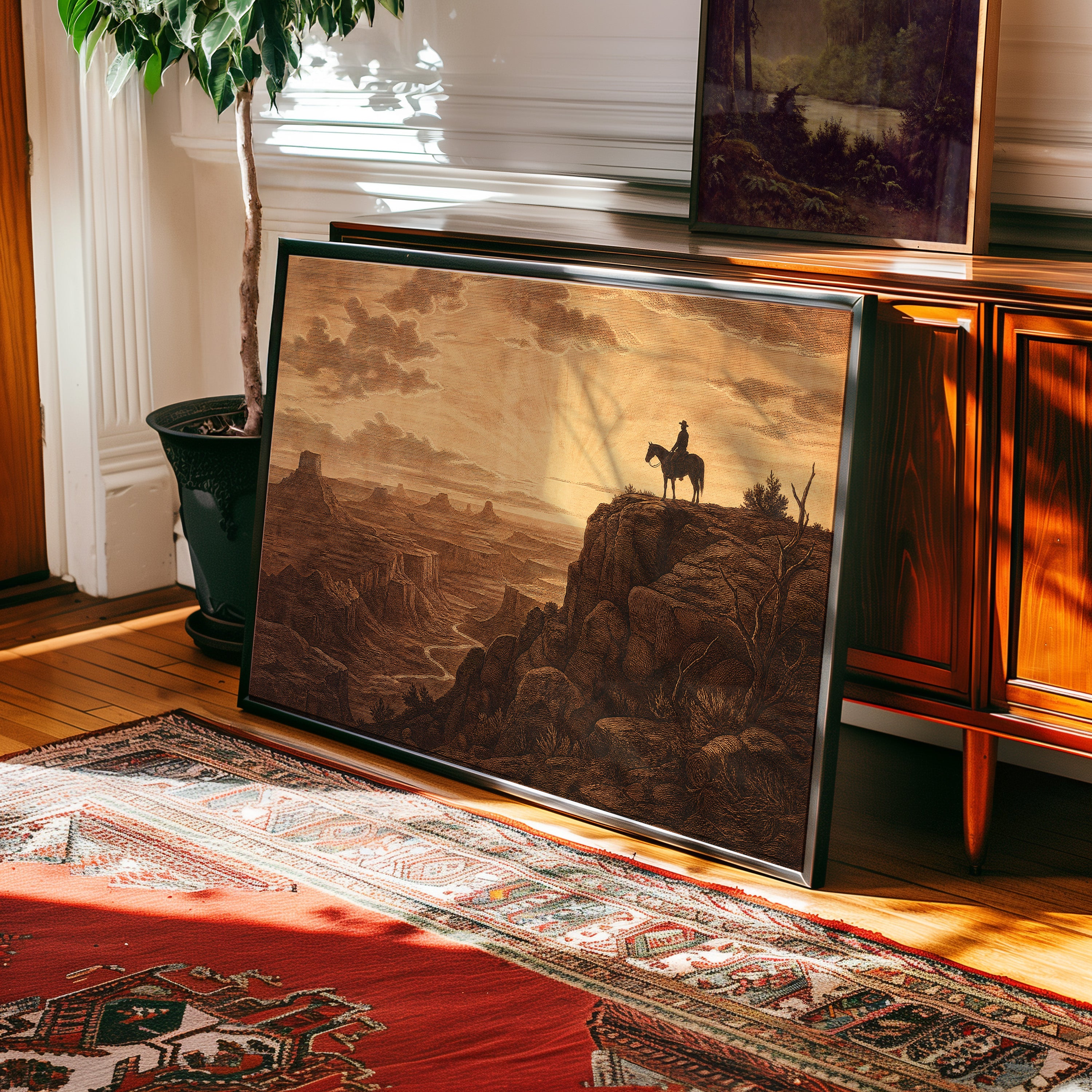 Etching-style print of a cowboy on horseback silhouetted against a sunrise canyon — view 2