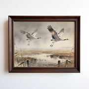 Watercolor painting of two cranes flying over a misty wetland marsh at dawn