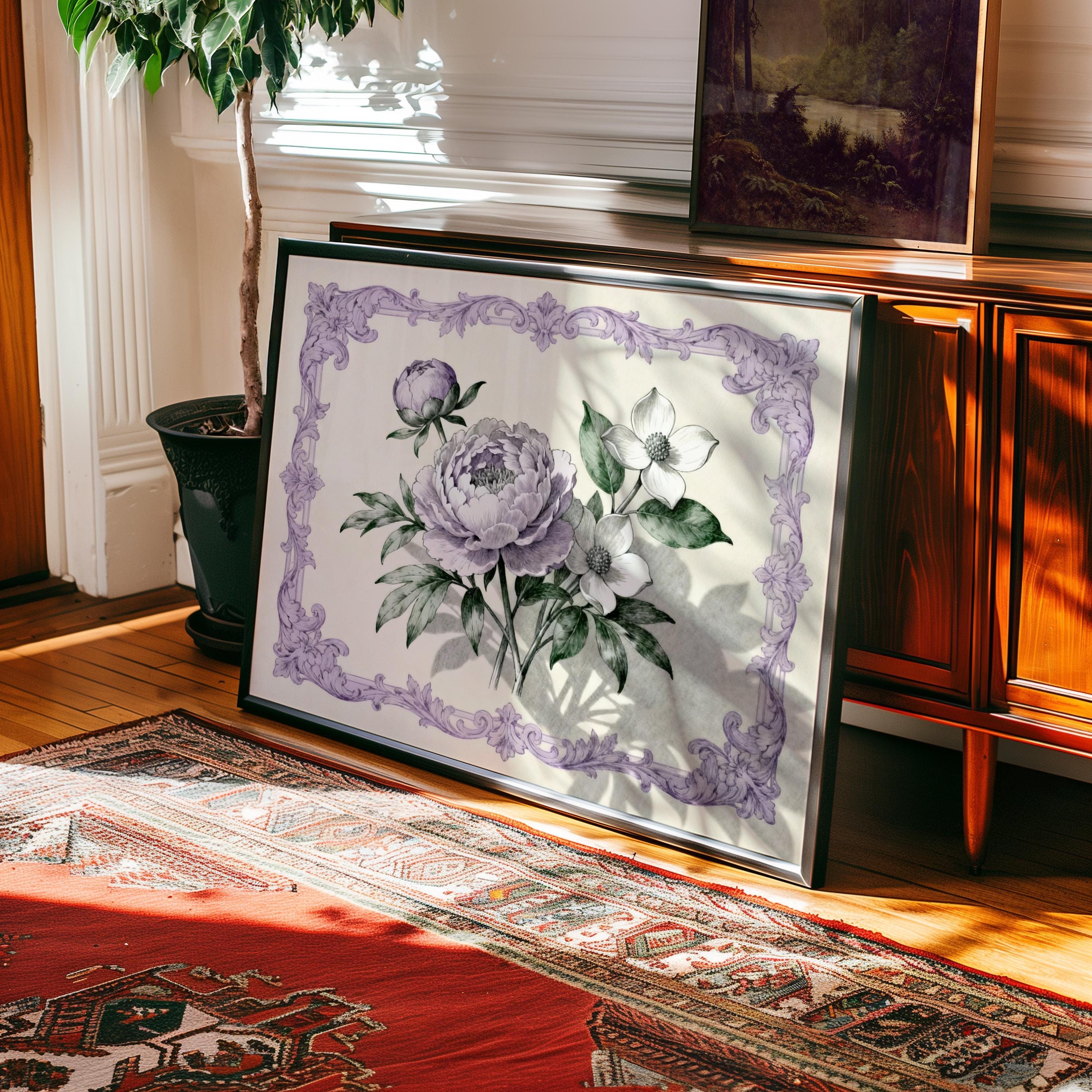 a framed painting of purple flowers on a wooden surface, with a rug and a plant in the background.