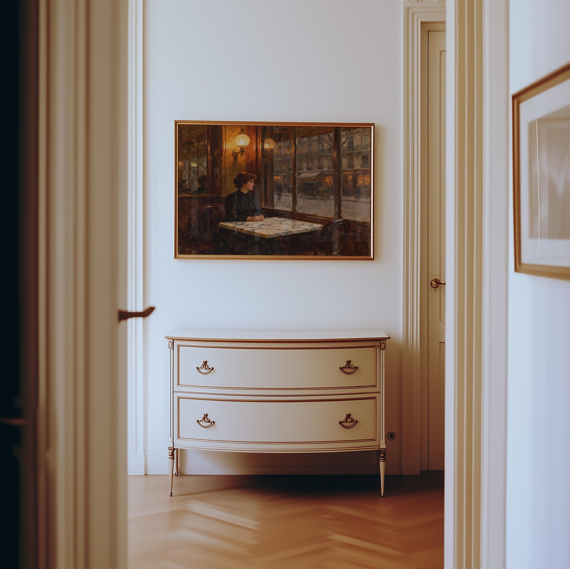a hallway with a painting of a woman sitting at a table, a white dresser with two drawers, and a doorway leading to another room.