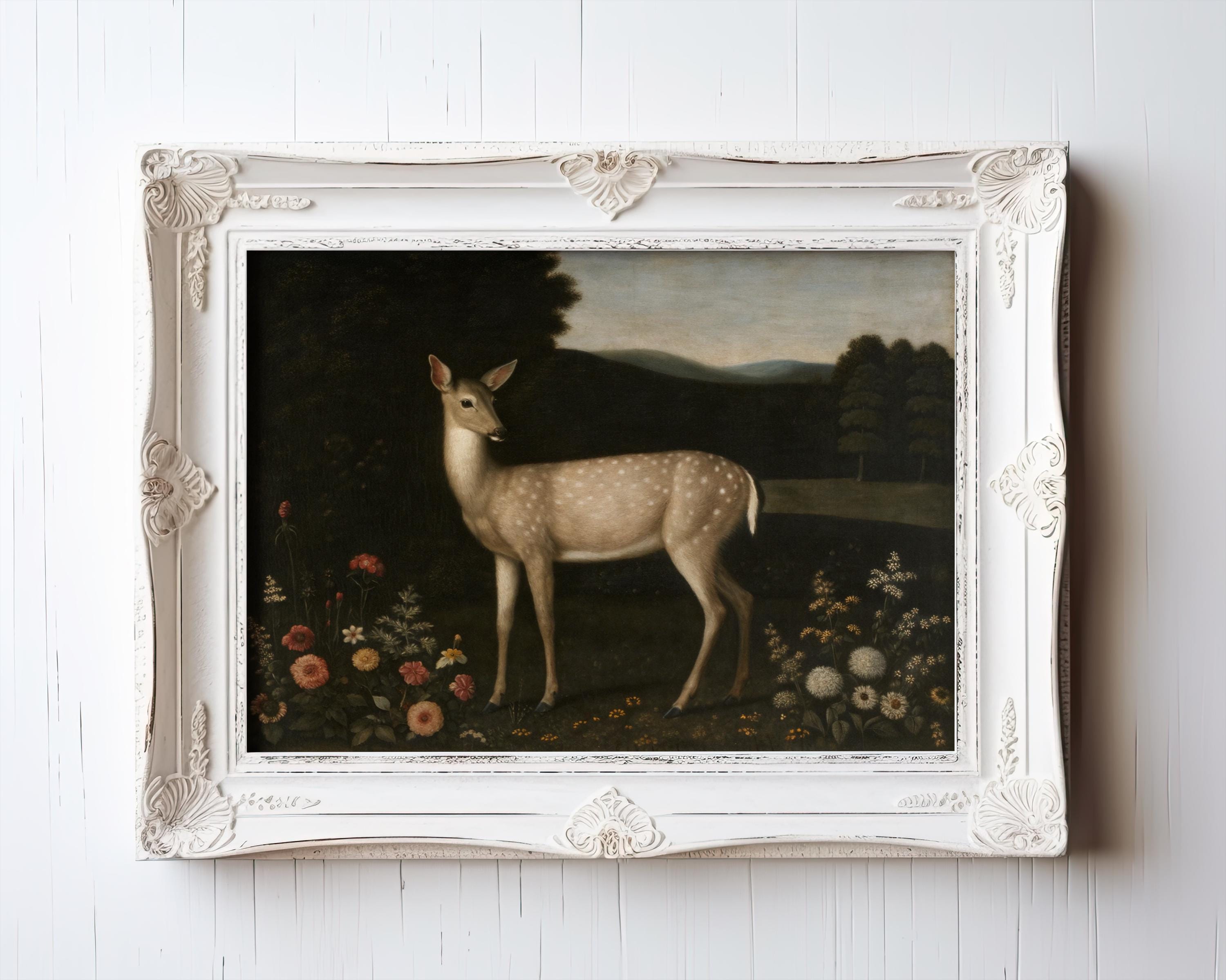 The Vintage Deer Art Print – Pastoral Animal Art with Floral Meadow, Rustic Home Décor accents a white wooden wall, offering archival quality from the West & Wild Art Archive—ideal for vintage art prints and framed art lovers.