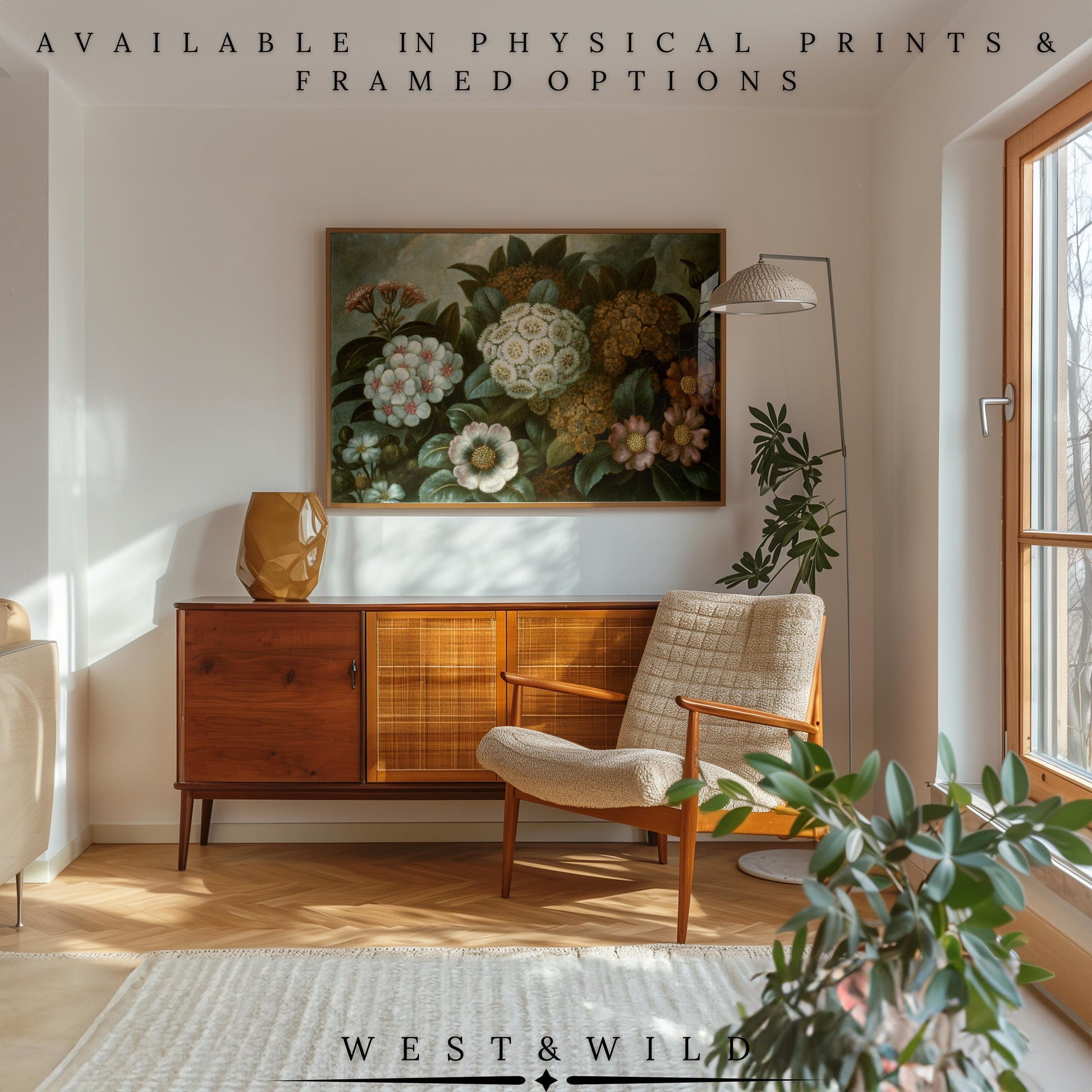 Mid-century modern living room with a wooden sideboard, beige armchair, floor lamp, houseplants, and sunlight streaming in. Enhance your space with the Botanical Floral Art Print – framed vintage blossom art from West & Wild.