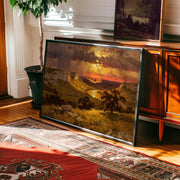 a large landscape painting hanging on a wall, depicting a scenic countryside with a river and mountains in the background.