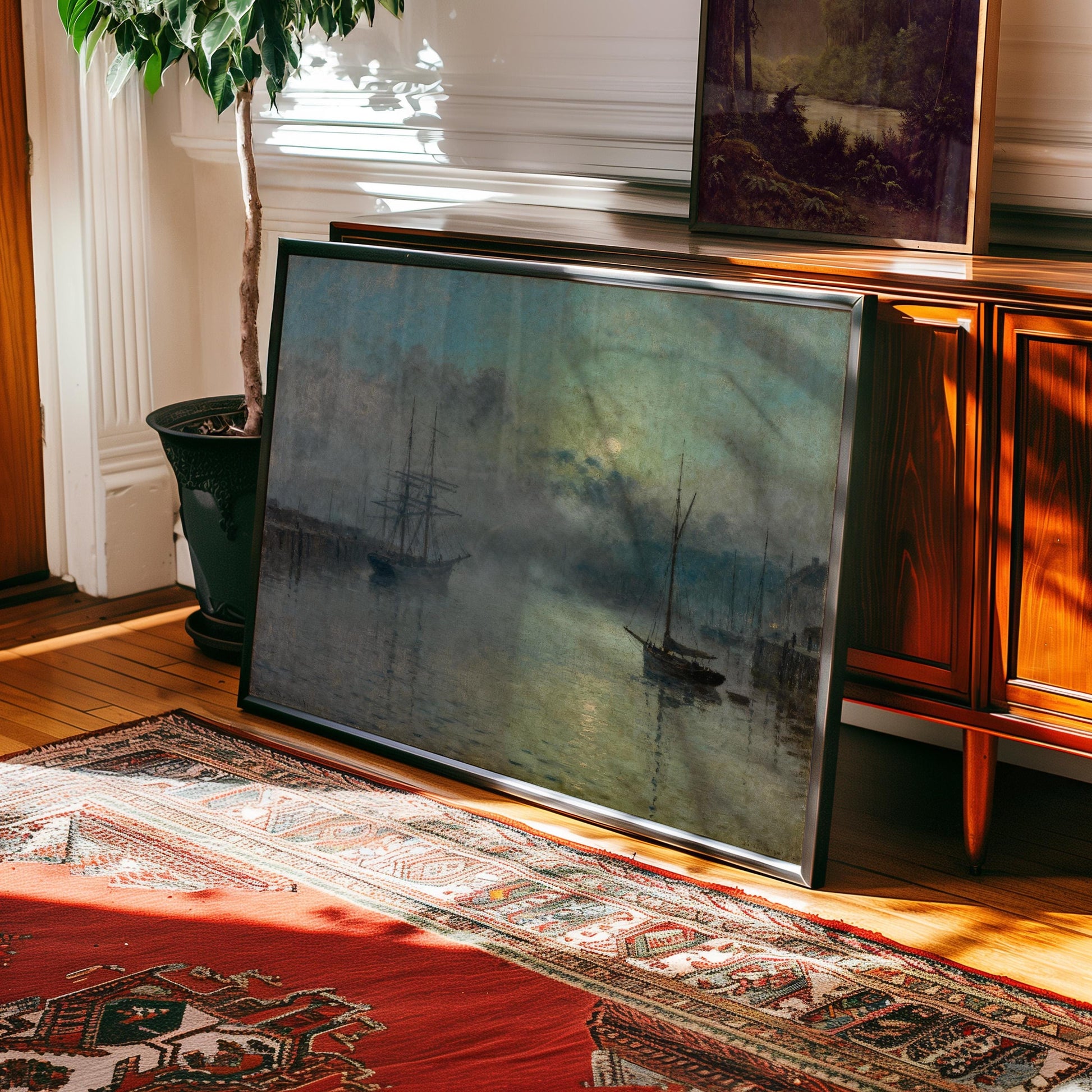 a large painting of a seascape with two ships in the water, displayed on a wooden cabinet in a room with a rug on the floor.