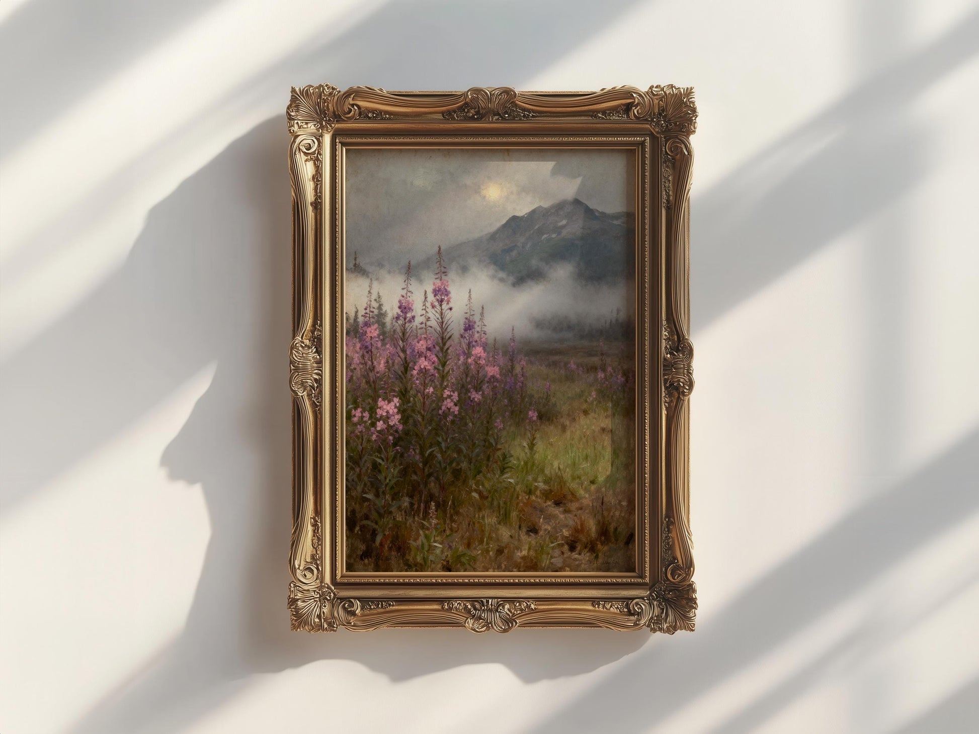 a painting of a field with pink flowers, hanging on a white wall.