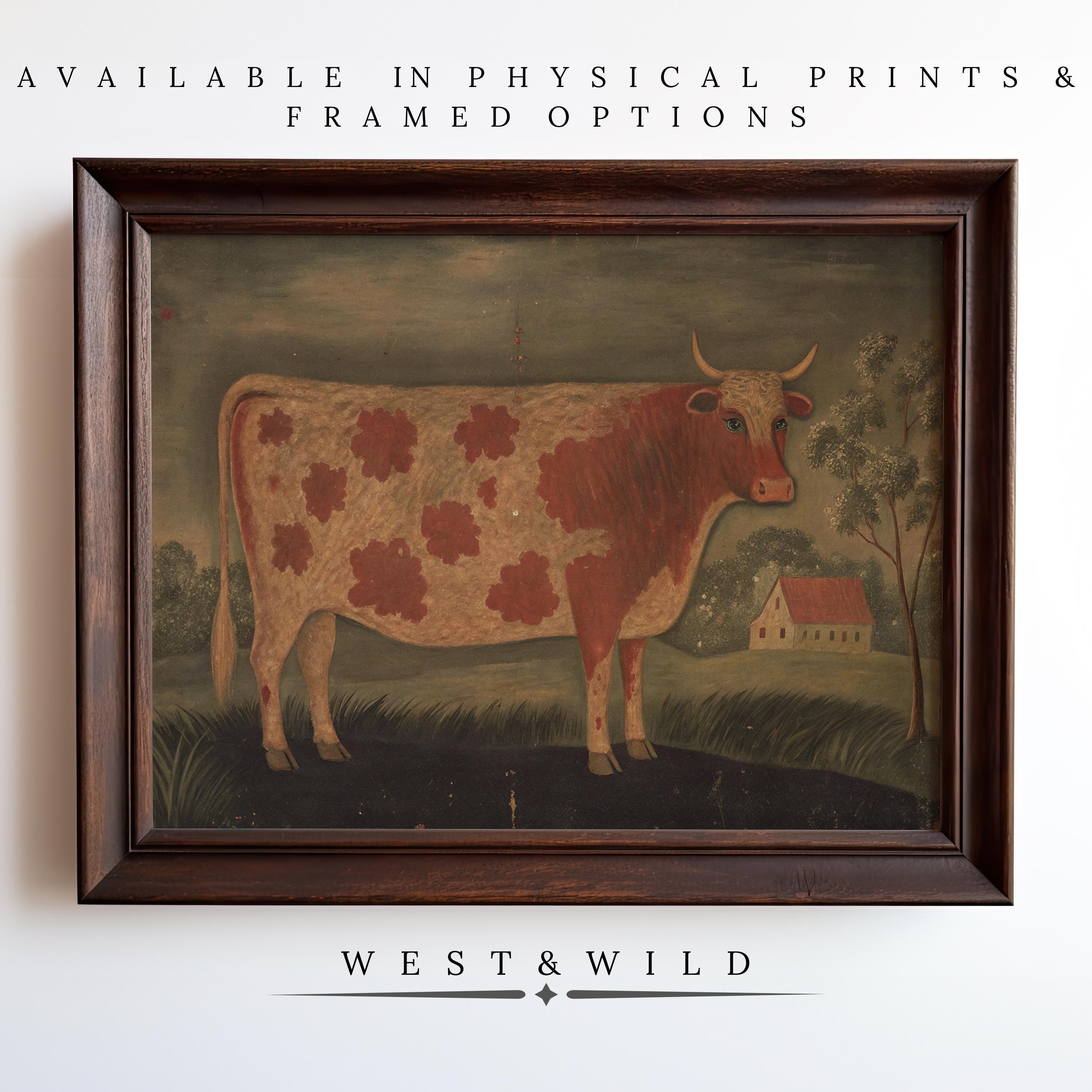 The Primitive Folk Art Cow - Rustic Farmhouse Wall Art features a brown and white cow in a grassy field with house and trees. Available as vintage art prints & framed art from West & Wild Art Archive. Spotted Cattle Print Decor.