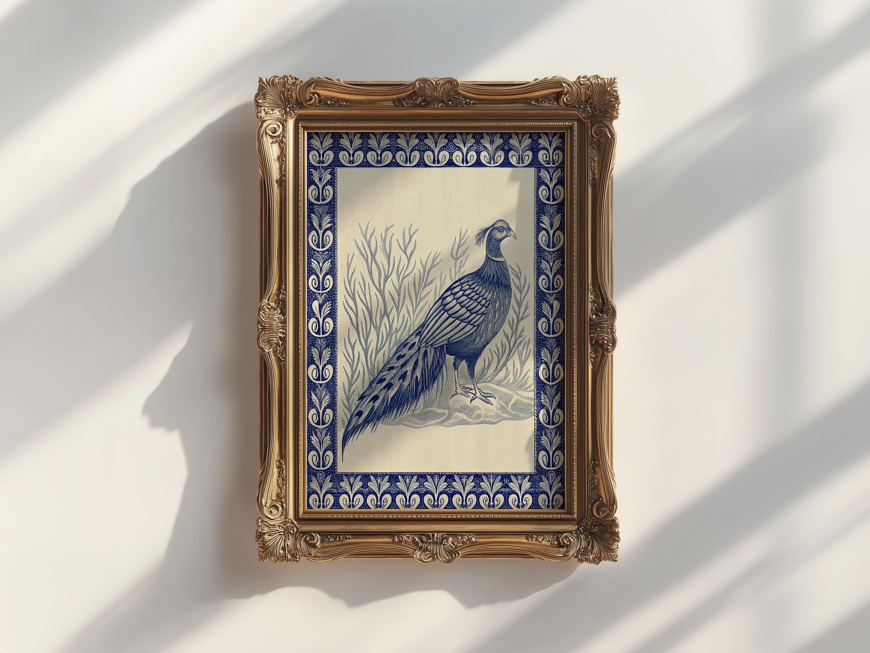 The Vintage Pheasant Wall Art features a blue-tone pheasant among grass, set in an ornate gold frame. This archival-quality, framed indigo bird artwork is from West & Wild Art Archive’s vintage art prints collection.