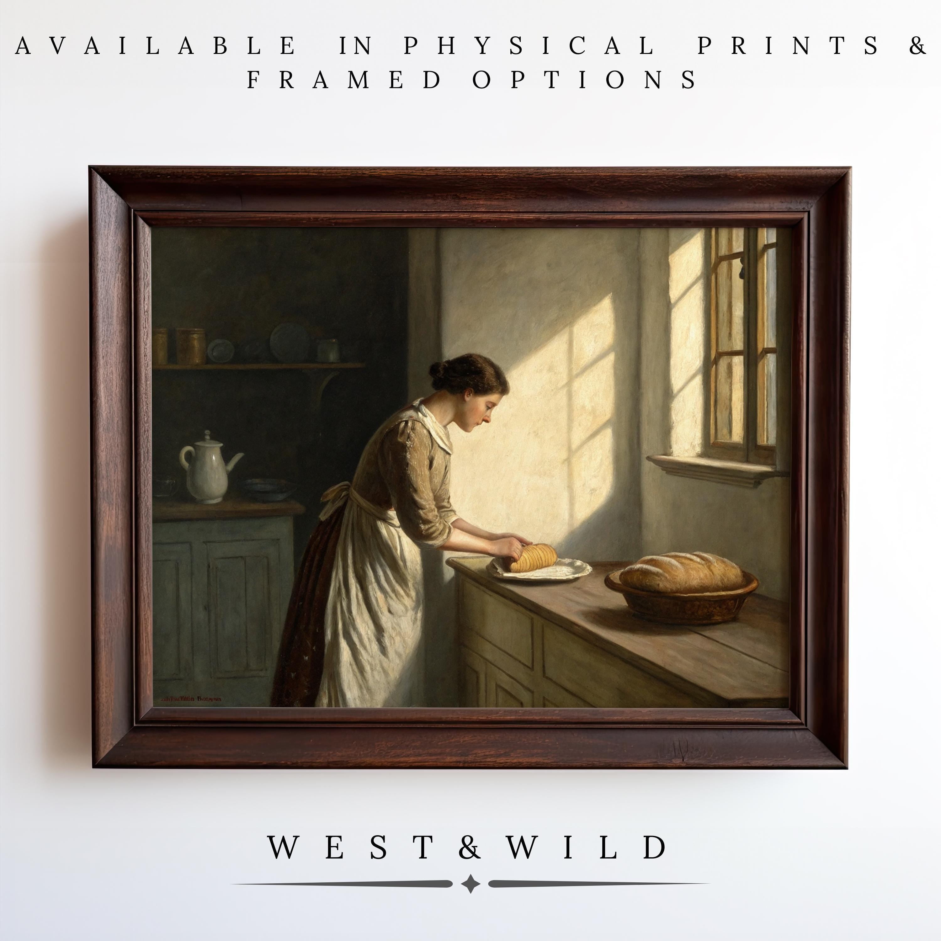 Victorian Kitchen Artwork - Framed Vintage Baking Art: Features a woman slicing bread on a sunlit kitchen counter with a bread basket. Available as physical prints & framed options. WEST & WILD.