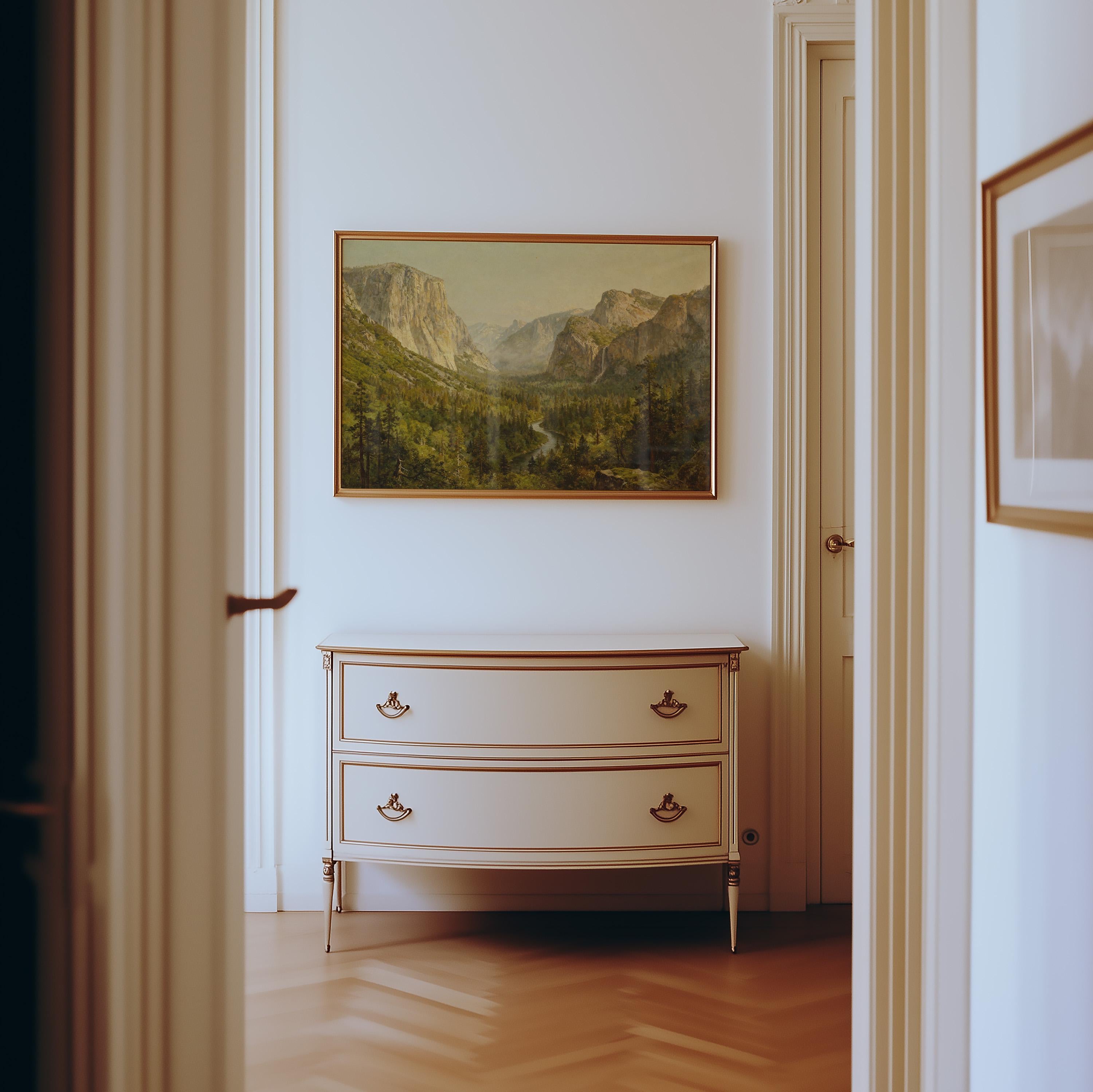 A light hallway leads to a white dresser with gold handles. Above it hangs the Yosemite Valley Art Print—Classic American Landscape With River View—adding vintage charm as sunlight softly illuminates the wooden floor and tranquil space.