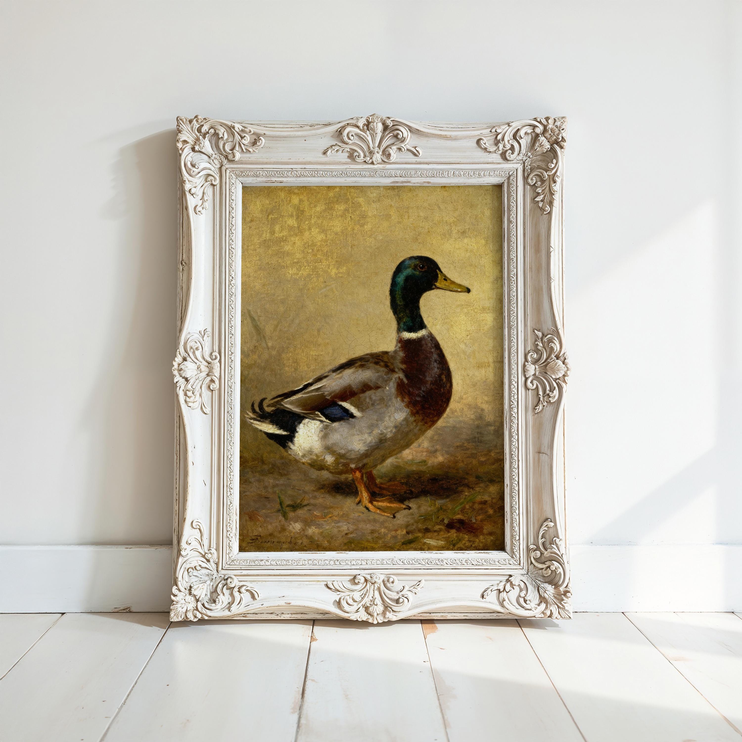 a painting of a duck in a white ornate frame, displayed on a white wall.