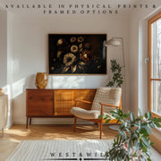 A mid-century modern living room with a wooden sideboard, beige armchair, plants, floor lamp, and the Golden Floral Art Print—vintage flowers in gold and bronze on black. Text above reads “AVAILABLE IN PHYSICAL PRINTS & FRAMED OPTIONS.”.