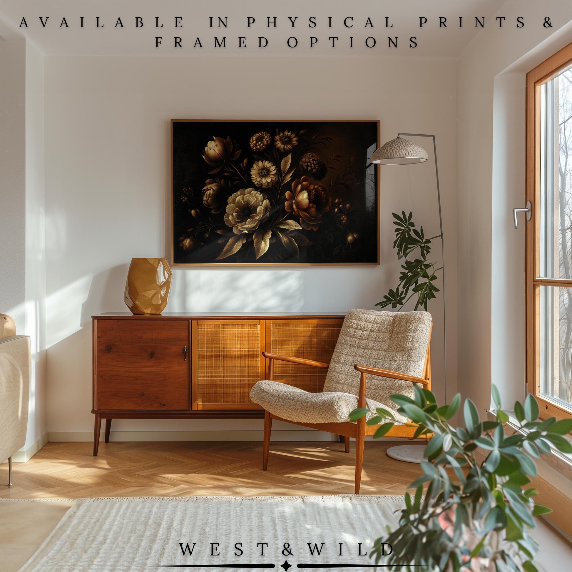 A mid-century modern living room with a wooden sideboard, beige armchair, plants, floor lamp, and the Golden Floral Art Print—vintage flowers in gold and bronze on black. Text above reads “AVAILABLE IN PHYSICAL PRINTS & FRAMED OPTIONS.”.