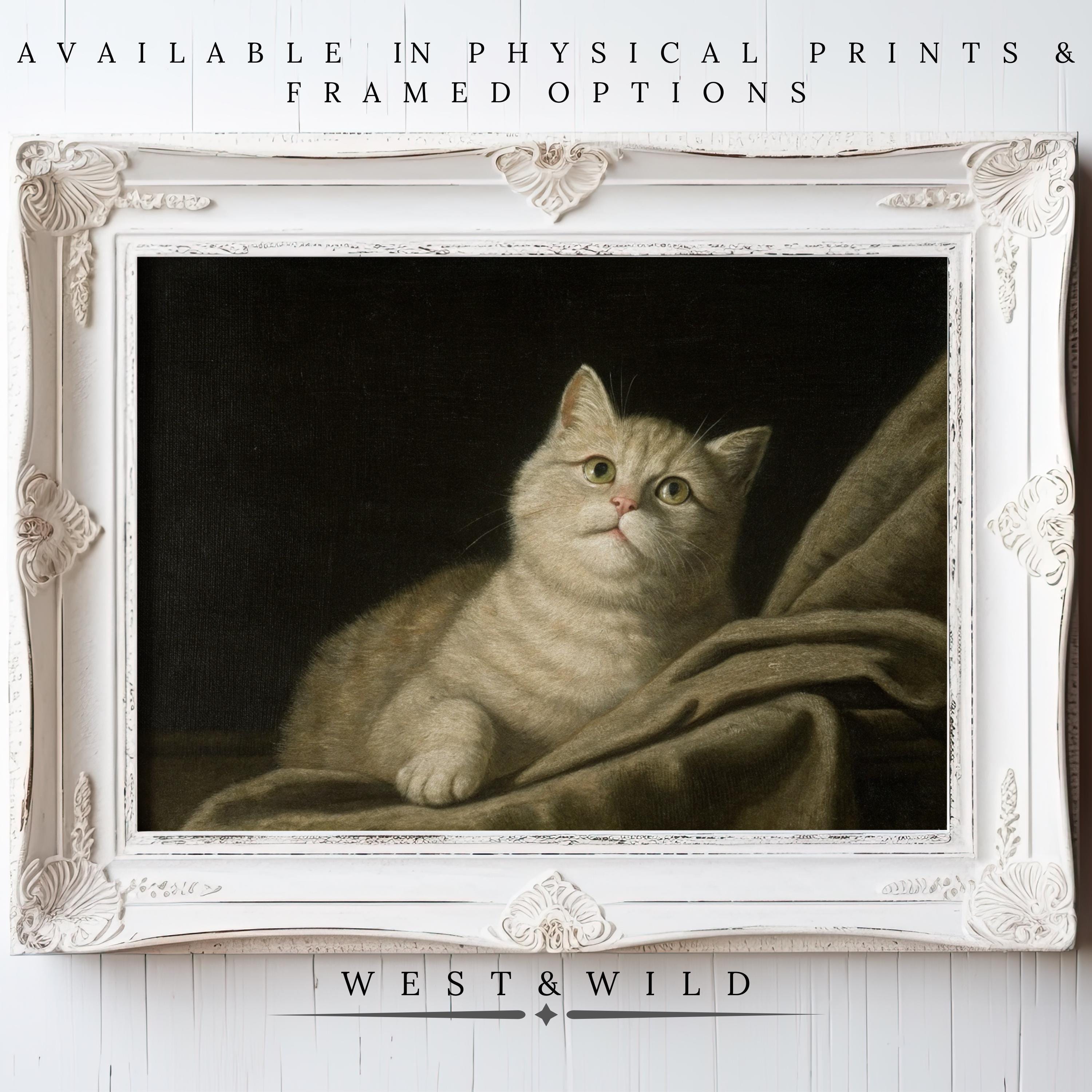 Vintage Cat Art - Cozy Beige Cat Wall Decor features a light gray tabby on draped fabric in an ornate white frame. Available as physical prints & framed options from WEST & WILD—perfect cat nursery wall art.