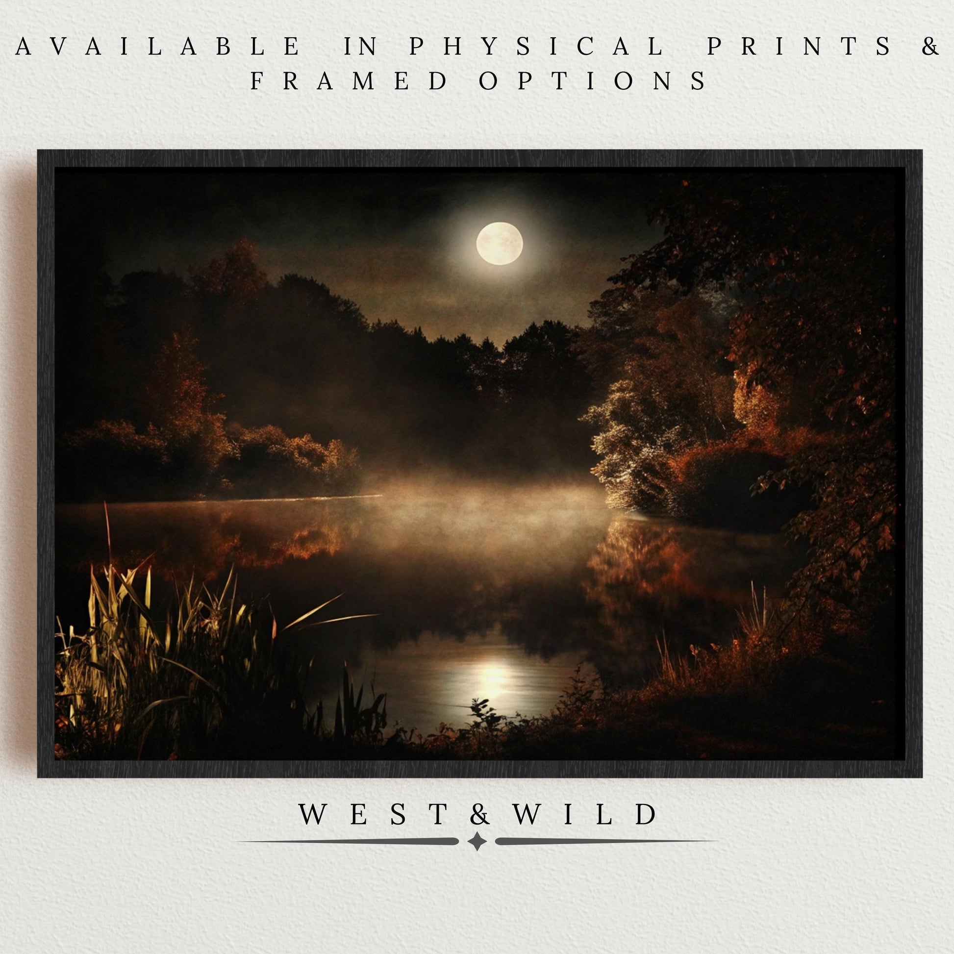 The Moonlit Lake Art Print – Foggy Night Landscape with Full Moon Glow features mist, trees, and still water in a framed display on a white wall. Available in Physical Prints & Framed Options. Below: West & Wild. Ideal for rustic cabin decor.