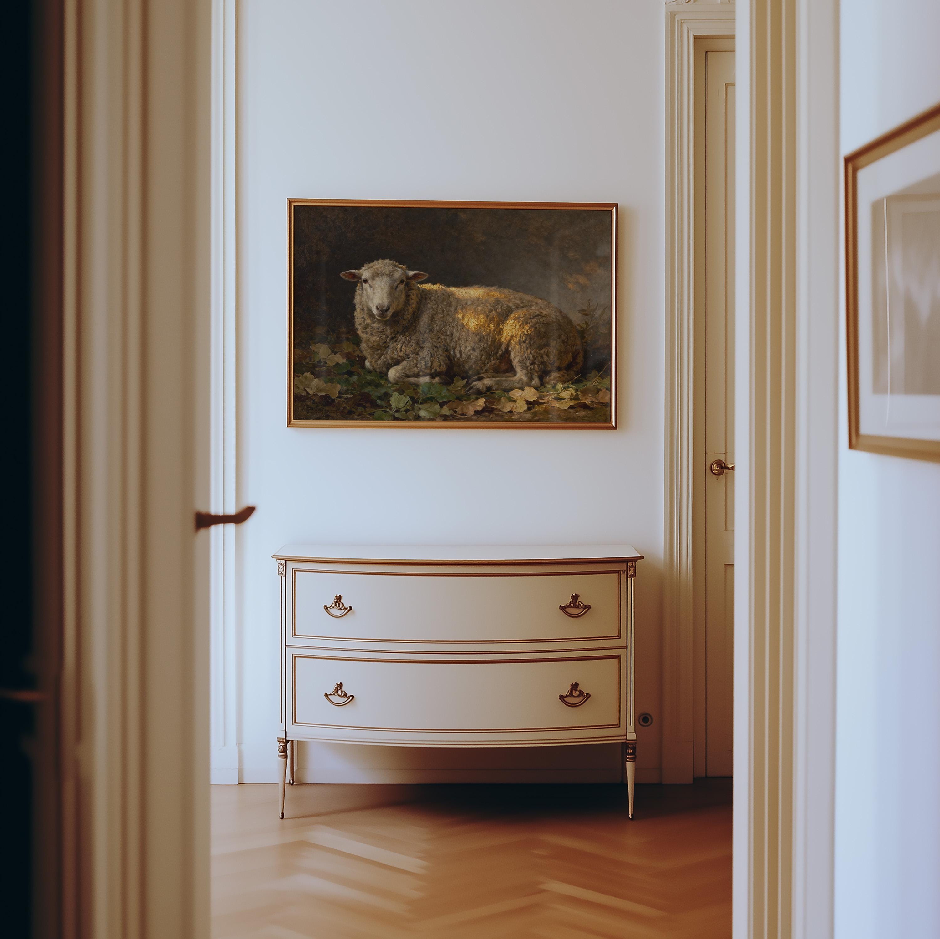 A hallway with light walls and wood floors features a two-drawer dresser, above which hangs the Resting Sheep Art Print – Vintage Farmhouse Wall Art With Warm Earth Tones, softly illuminated by natural light.