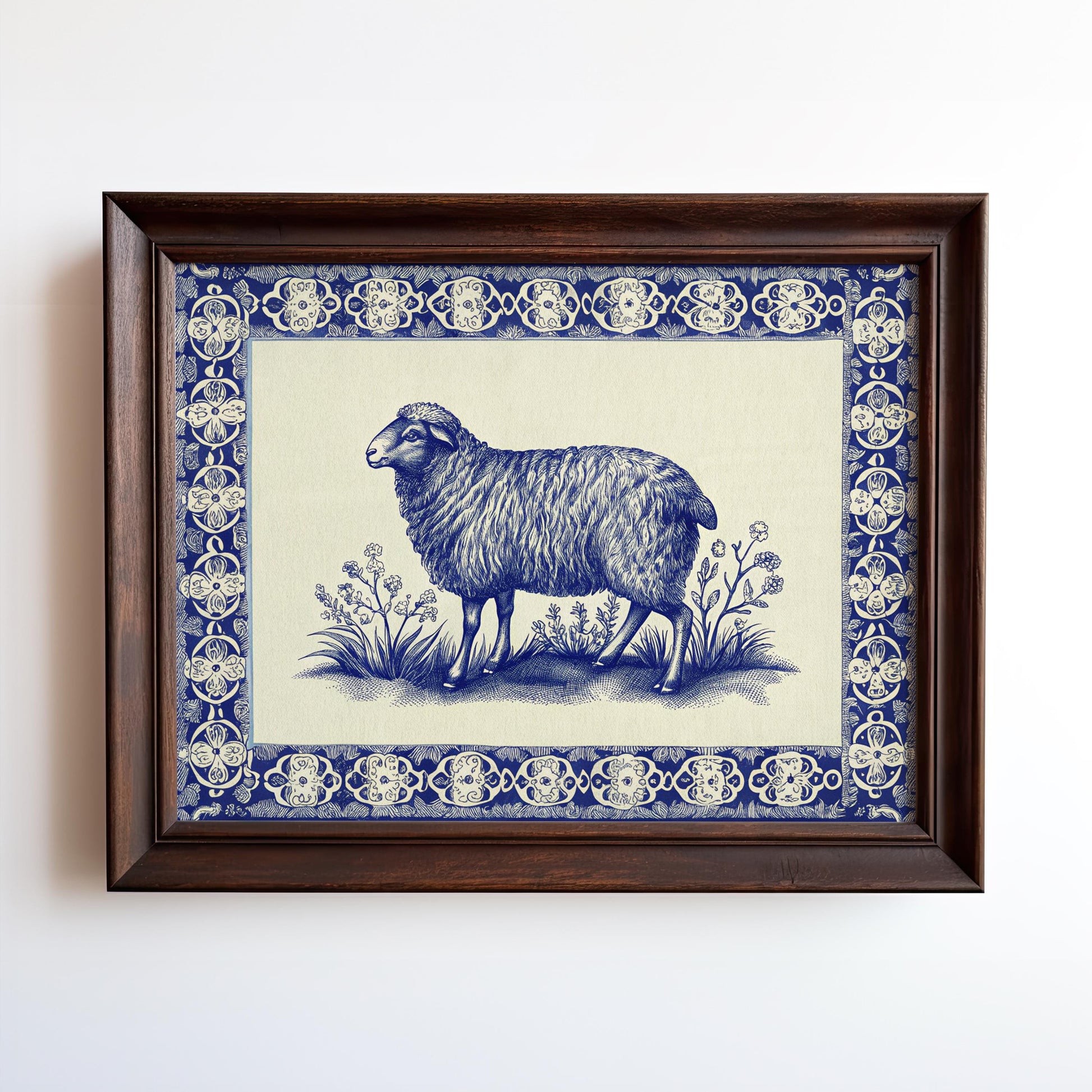 The Framed Sheep Print – Blue China Pattern Rustic Wall Art features a sheep among plants with an ornate blue and white border, presented in your choice of wood or metal frame. Vintage archival print from West & Wild Art Archive.
