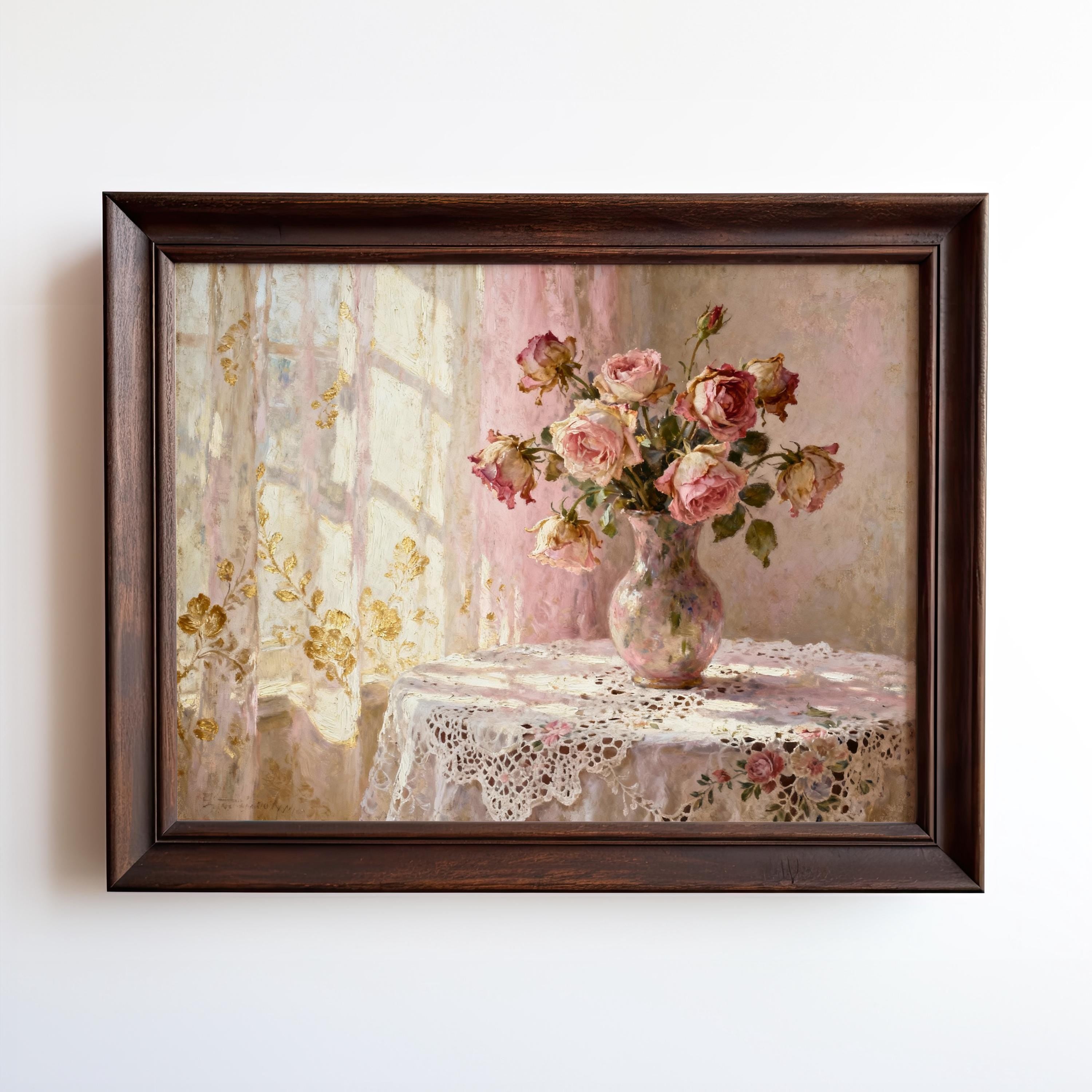 A framed painting depicting a vase of pink roses on a lace tablecloth, with a window and curtains in the background.