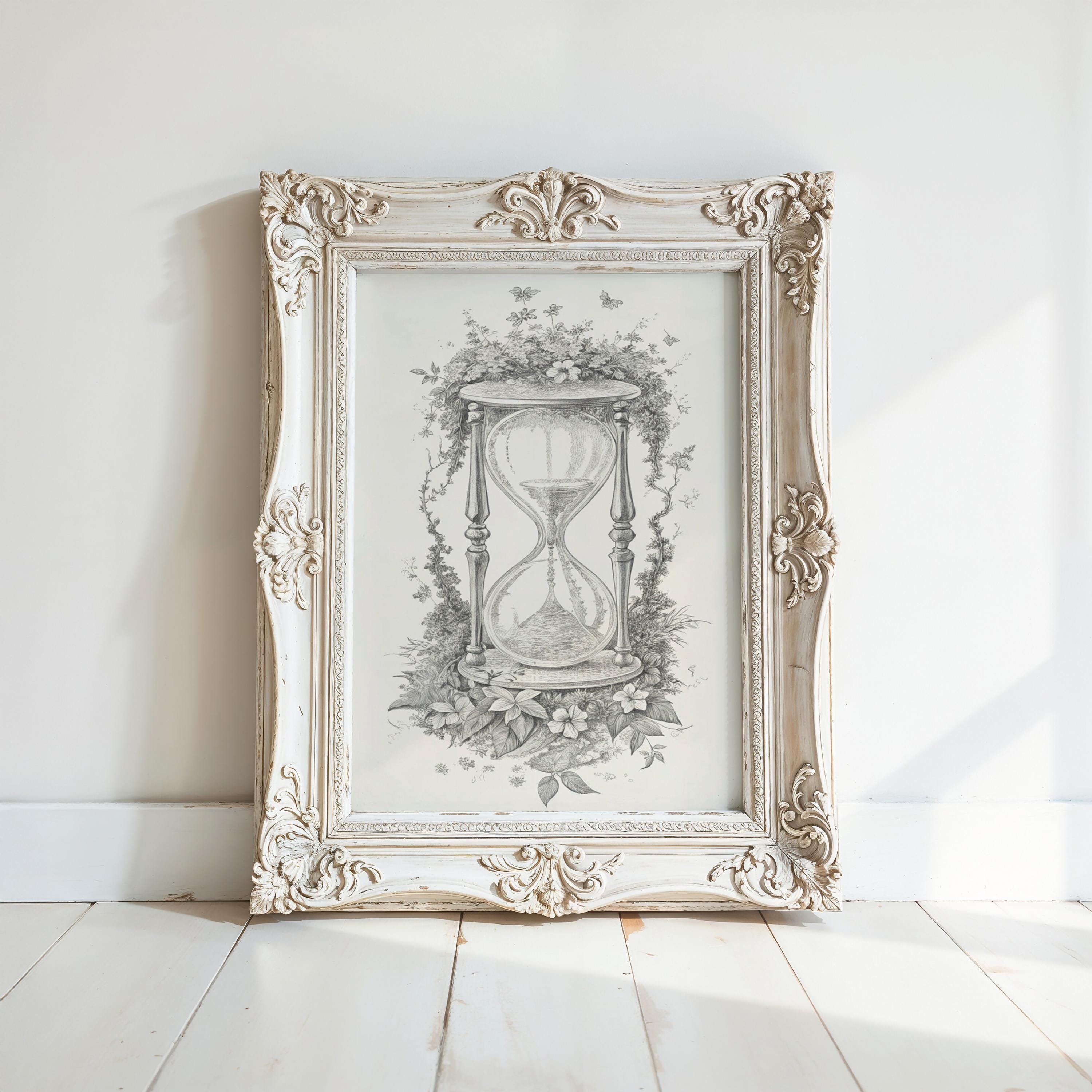 A framed illustration of an hourglass is displayed on a white wall, with a decorative frame surrounding it.