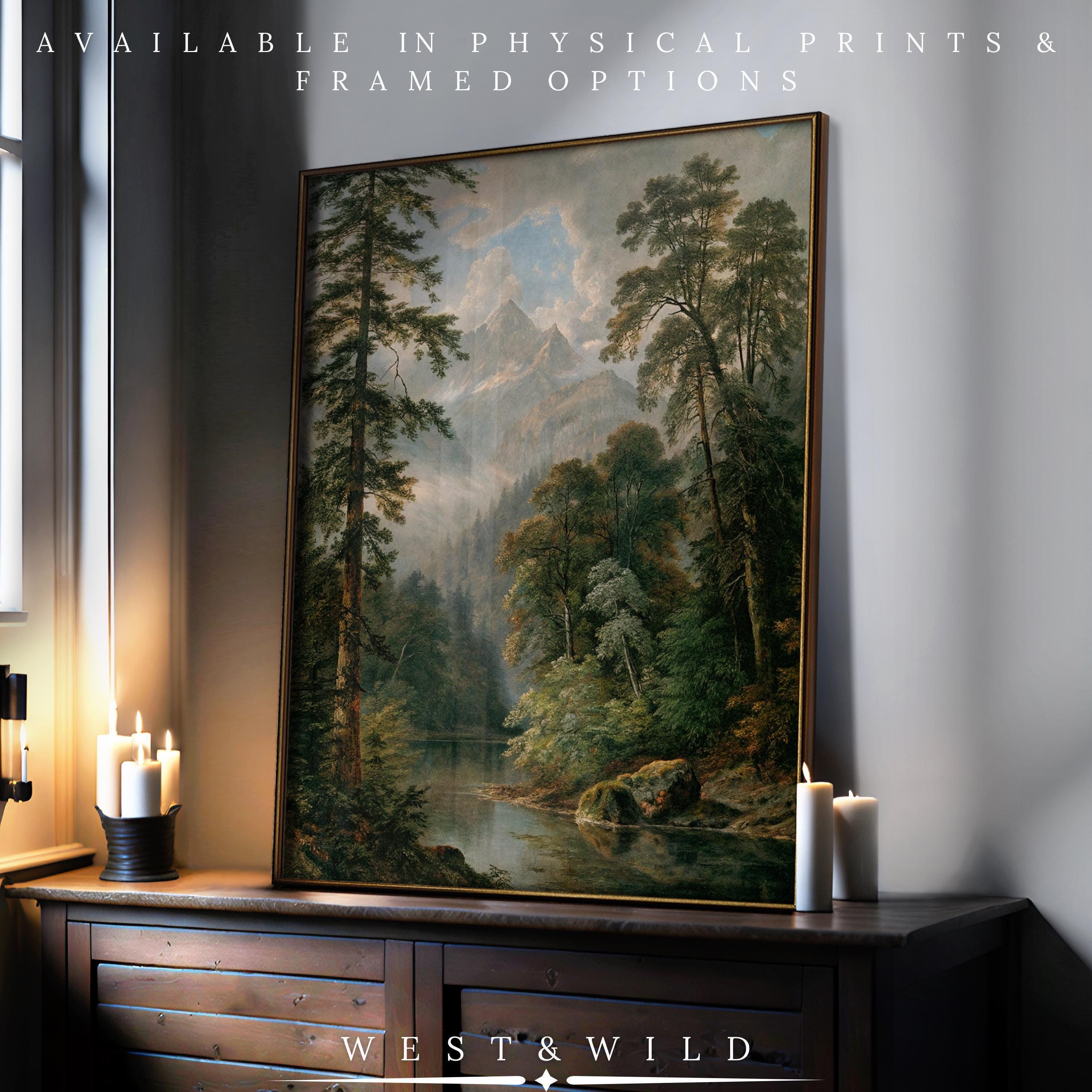 A large Olympic National Park Art – Framed Mountain Landscape Print sits on a wooden dresser by lit candles, basking in natural light. Ideal for Pacific Northwest decor. Available as physical prints & framed options from West & Wild.