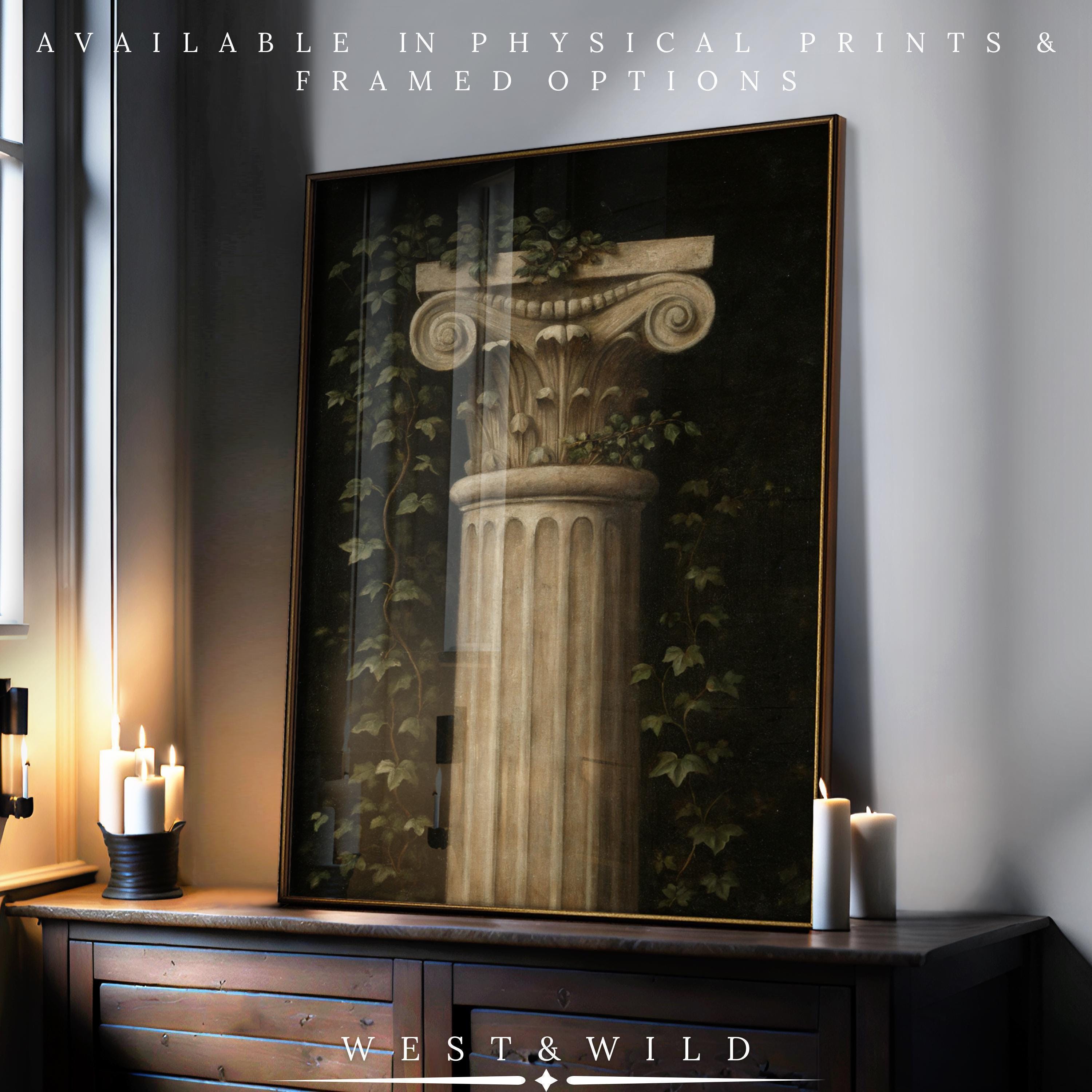 A Classical Column Wall Art print—Roman Pillar Painting with Ivy—is displayed on a dresser with candles and window light. Available as vintage art prints and framed art from the West & Wild Art Archive.