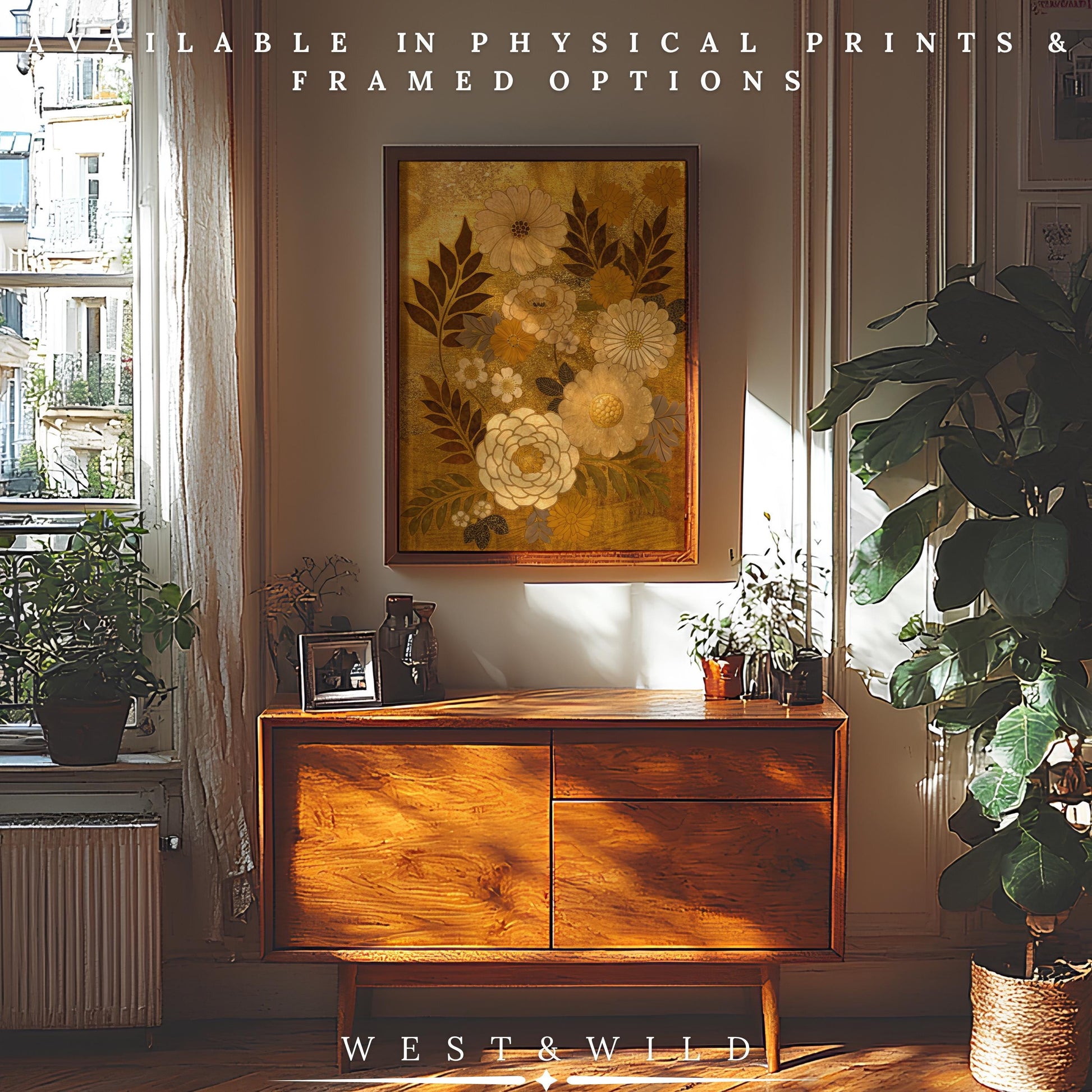 A sunlit room with a mid-century sideboard, potted plants, and the Gold Leaf Floral Art | Japanese Botanical Print – Elegant Cream Gold Flowers Framed on the wall. Above: Available in archival quality prints & framed options. Below: West & Wild.