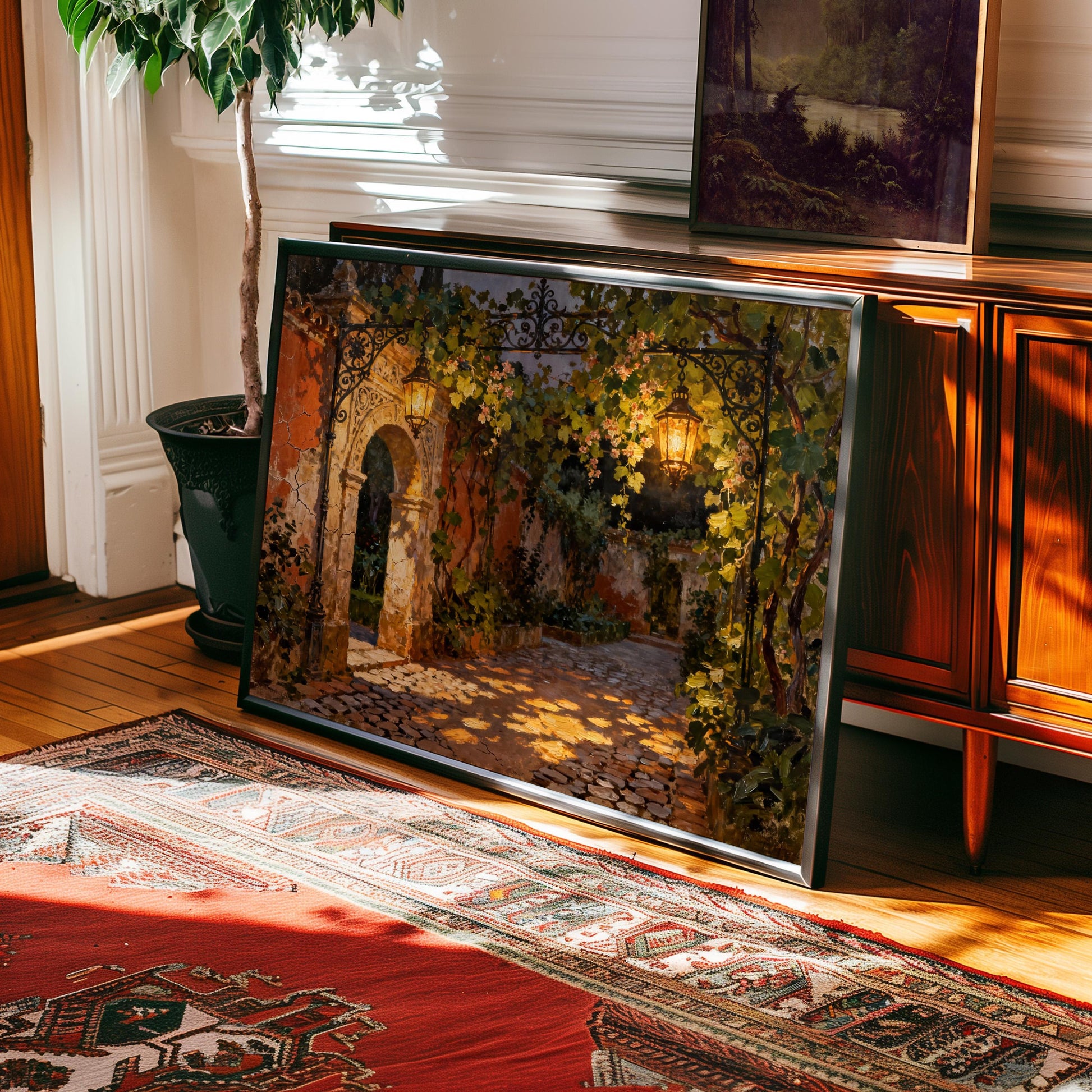 a large framed painting depicting a garden scene with a stone archway and a lantern hanging above it, placed on a wooden floor next to a rug.