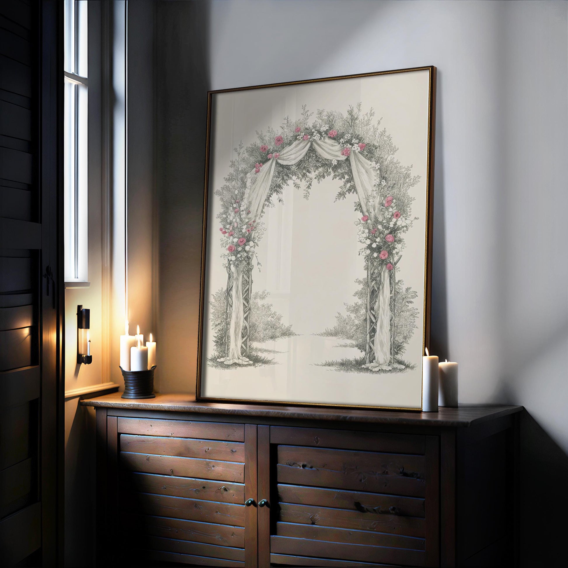 a large framed picture of an archway adorned with flowers, placed on a wooden cabinet or dresser.