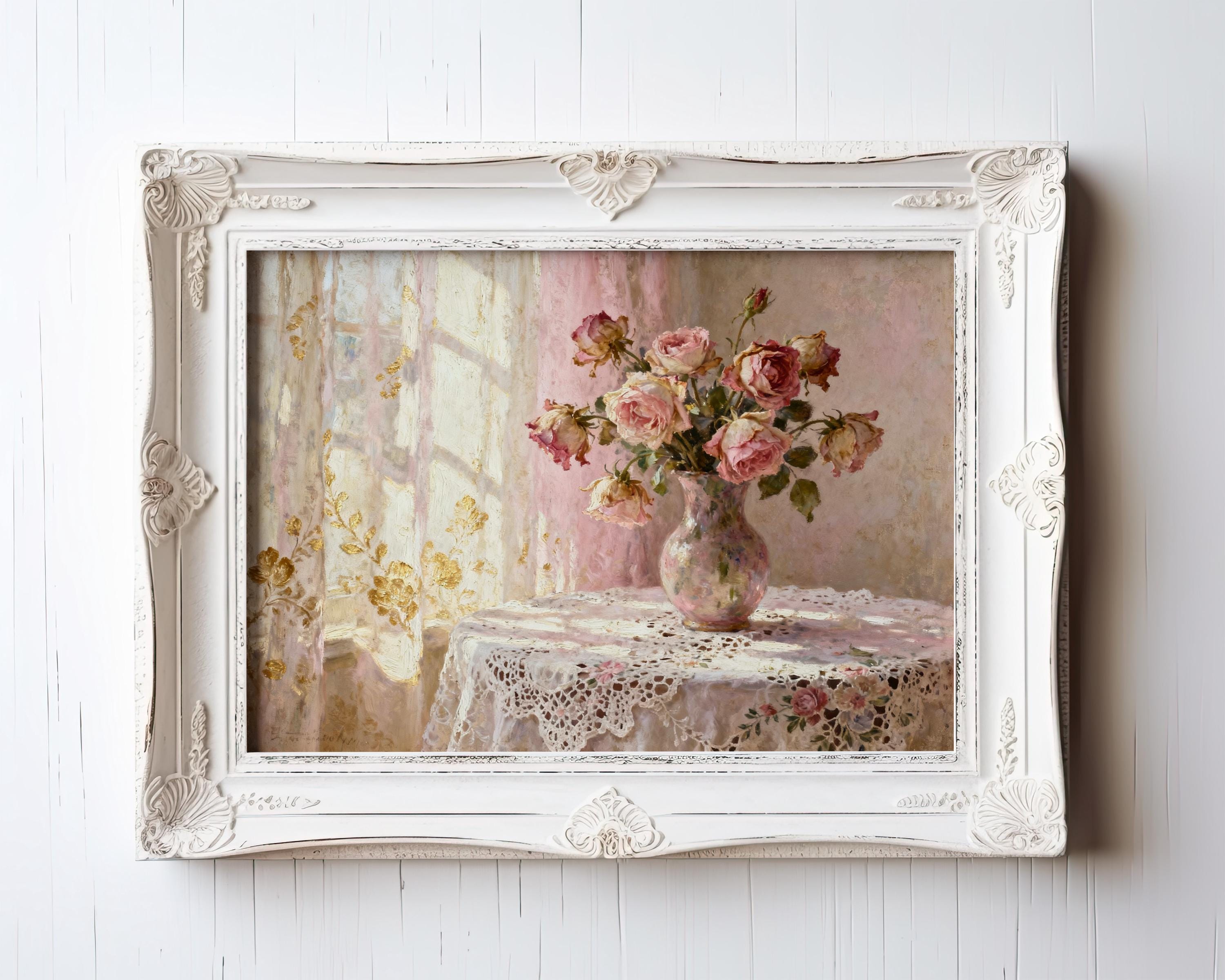 A framed painting depicting a vase of pink roses on a lace tablecloth, set against a window with white curtains.