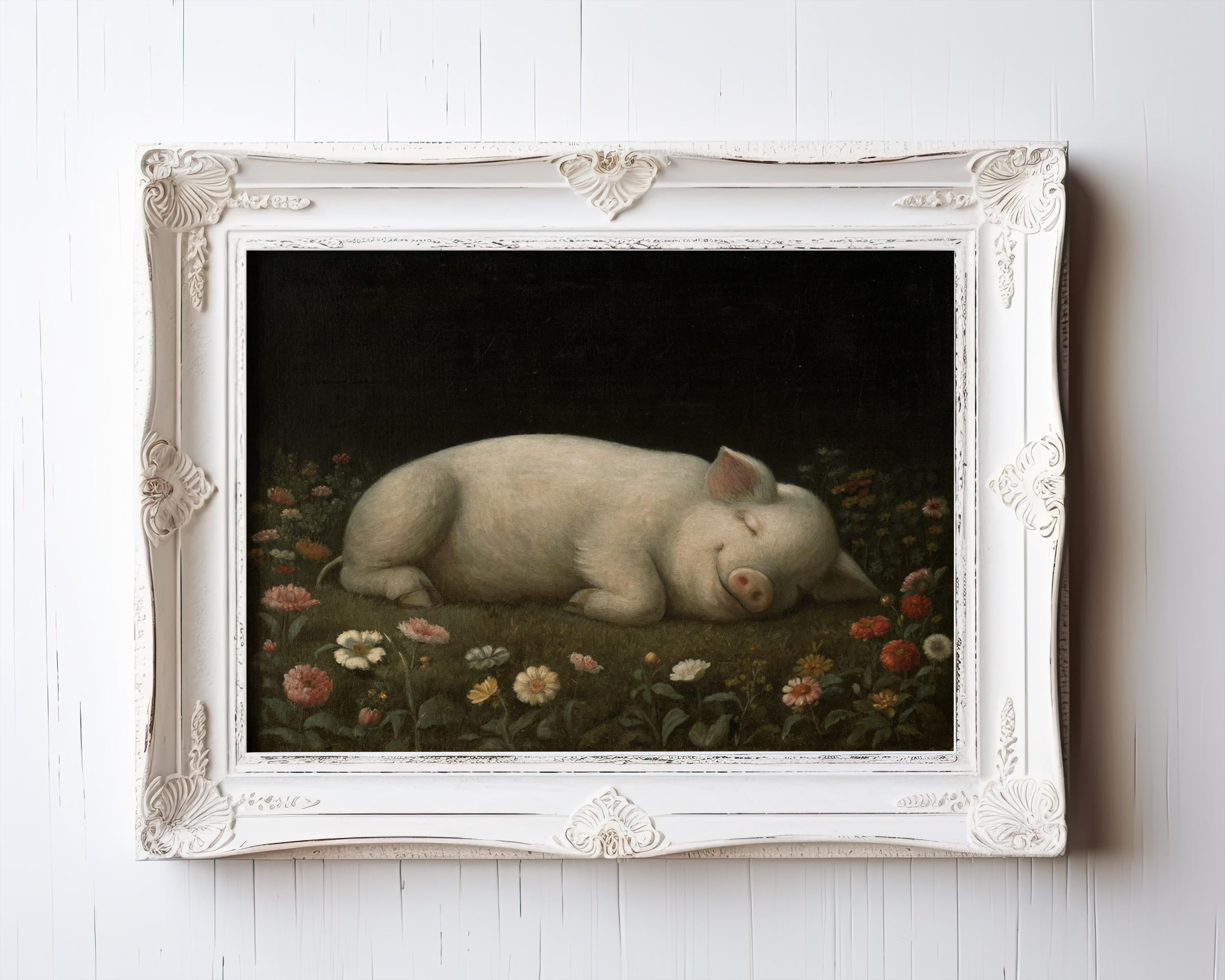 A framed Vintage Pig Wall Art print features a sleeping piglet in wildflowers, perfect for rustic farm decor. Displayed in an ornate white frame, this elegant artwork adds whimsy and charm to any room.