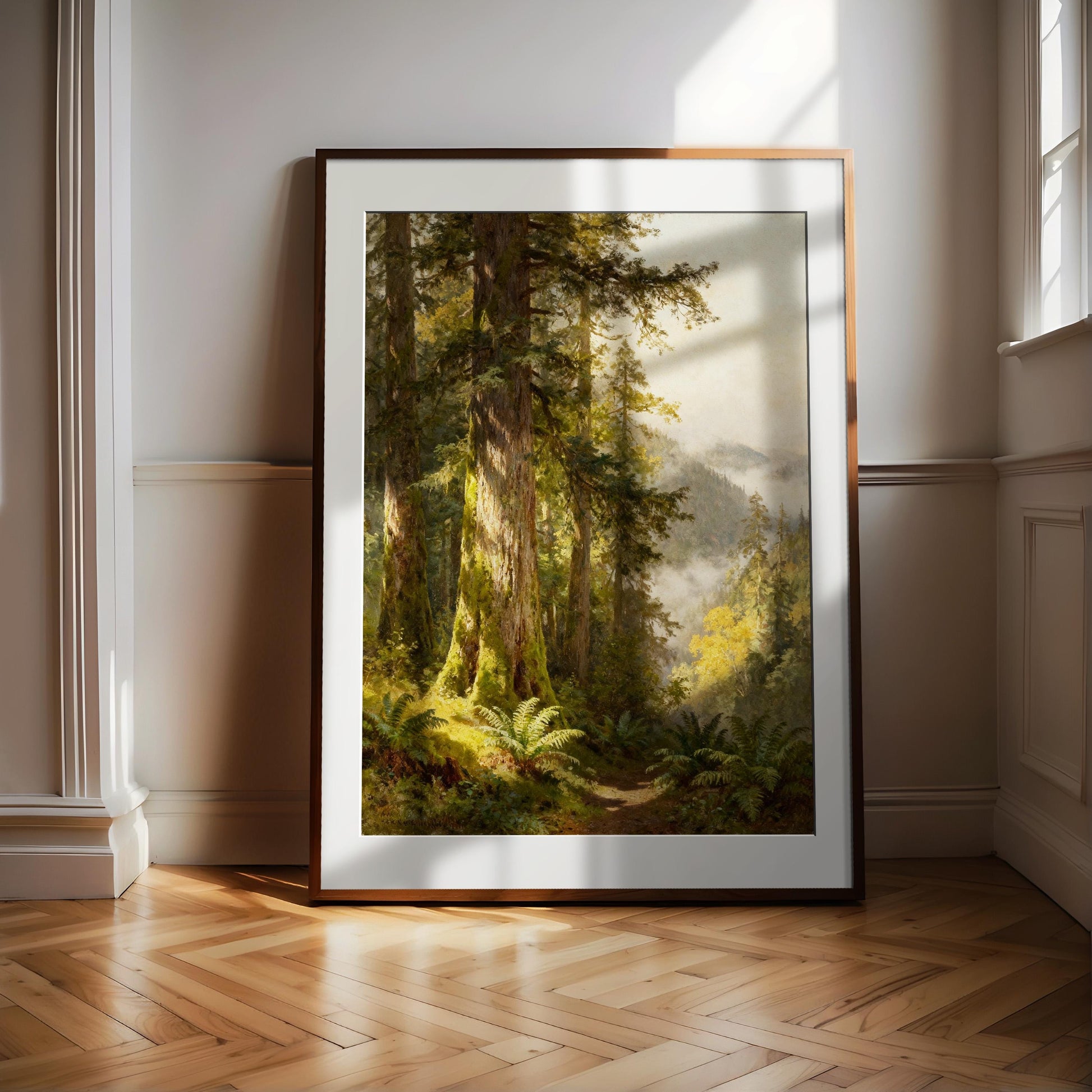 a large, framed painting of a lush, forested landscape with towering trees and a winding path through the undergrowth.